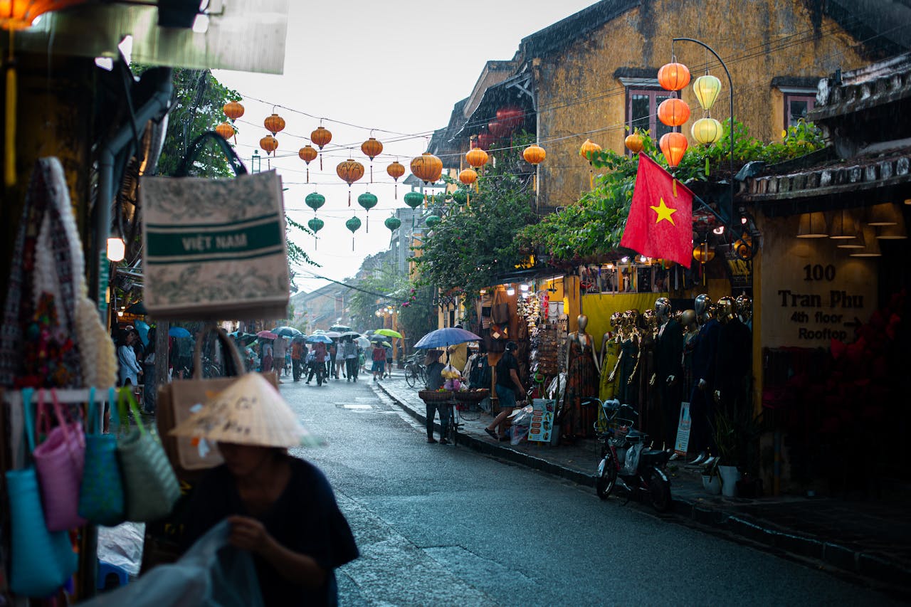 Explore the colorful, lantern-adorned streets of Hội An, Vietnam, bustling with life and culture.