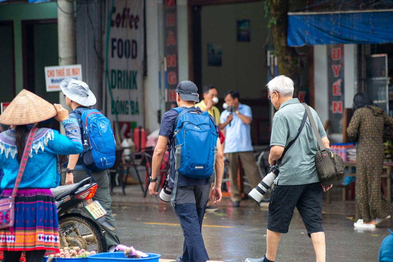 Photographers capturing vibrant scenes at Bắc Hà market, showcasing local culture in Lào Cai, Vietnam.